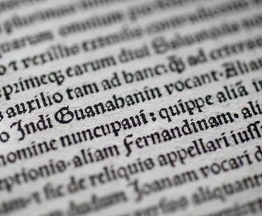 Detail of a printed page shows text in Latin.
