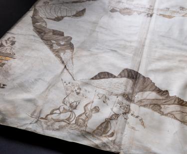Detail of a manuscript map shows coastal profiles and women or mermaids holding the flags of Ireland, Scotland, and England.